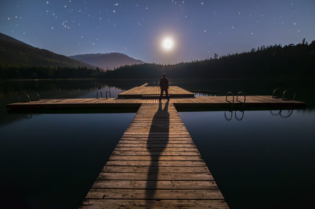 A solitary person standing among a crowd, symbolizing emotional loneliness despite being surrounded by people.