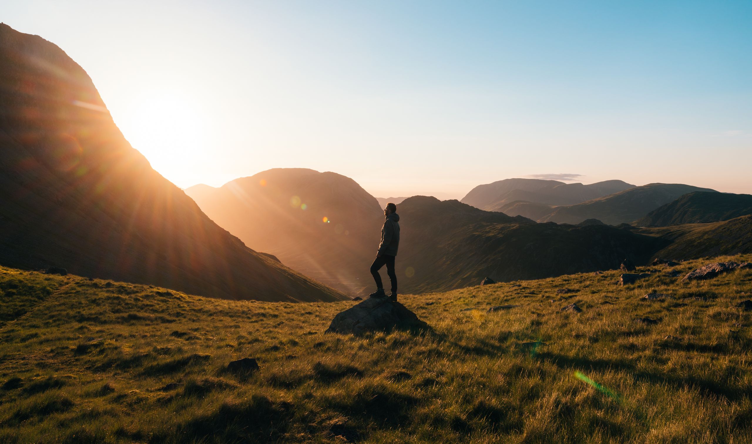 A person standing alone at sunrise, symbolizing life's lessons, healing, hope, and emotional growth.