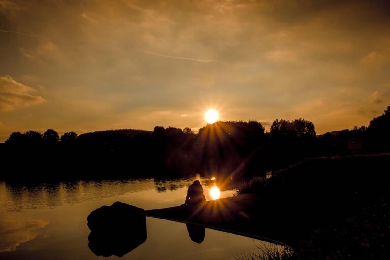sunset, sun, shine, sunbeams, lake, heaven, clouds, evening atmosphere, setting sun, reflection, boy, sitting, sit on a stone, nature, enjoy, alone, lost in thought, dreams, silence, quiet, trees, dusk, peaceful